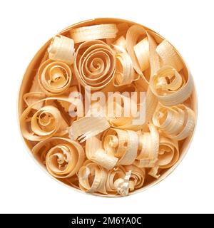 Spiral shaped wood shavings in a round chipwood box. Wooden spirals, made with a hand plane from dried spruce wood, in a circle shaped wood chip box. Stock Photo