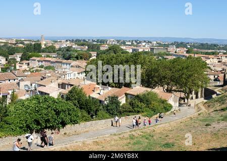 Carcassonne, France - Tourists walk from the old hilltop fort down to the centre of Carcassonne. 2022. Stock Photo