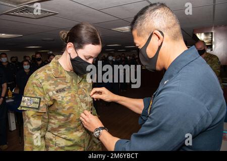 PACIFIC OCEAN (May 10, 2022) Captain Hank Kim, Pacific Partnership 2022 (PP22) mission commander (right), promotes Australian Army Lieutenant Isabella Negus to Captain aboard the Military Sealift Command hospital ship USNS Mercy (T-AH 19), May 10 while underway for PP22. Now, in its 17th year, Pacific Partnership is the largest annual multinational humanitarian assistance and disaster relief preparedness mission conducted in the Indo-Pacific. Stock Photo