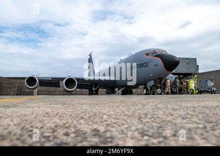 Aircrew from the 909th Air Refueling Squadron load equipment into a U.S. Air Force KC-135 Stratotanker to prepare for an aerial refueling mission at Kadena Air Base, Japan, May 10, 2022. The 909th ARS plays a crucial role in promoting peace and stability in the Indo-Pacific, providing aerial refueling so Kadena can deliver airpower any time, anywhere. Stock Photo