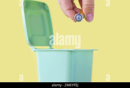 woman hand throwing in trash mini small garbage bin can broken smartphone white paper napkin towel,burnt matches or broken cigarette,lithium battery Stock Photo