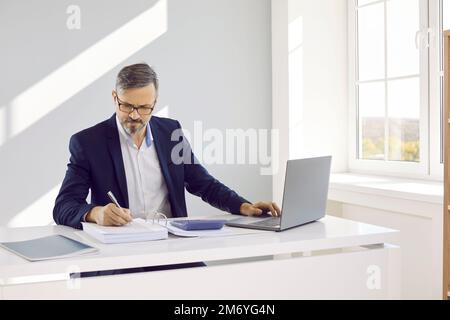 Businessman, auditor or financial accountant working on laptop computer in office Stock Photo