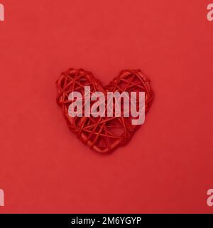 Valentines day red rotang heart on same color background. Monochromatic vivid color. Eco Valentine's day zero waste concept. Close up, copy space. Stock Photo