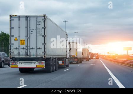 Lorry trucks cars in traffic jam at border zone custom, sunset time Stock Photo