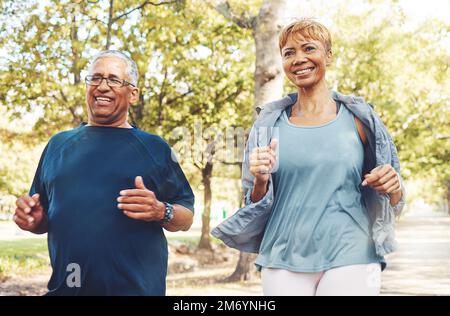 Senior runner couple, park and fitness with smile, teamwork or motivation for wellness in summer sunshine. Happy elderly man, woman and running team Stock Photo