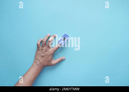 close up of man hand using pulse oximeter Stock Photo