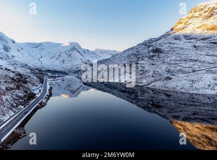 A Drone Photograph of a calm Llyn Ogwen in the snow covered Ogwen Valley situated in Snowdonia National Park North Wales UK Stock Photo