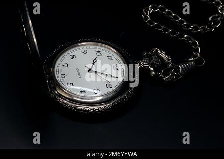 old brass pocket watch on dark background Stock Photo