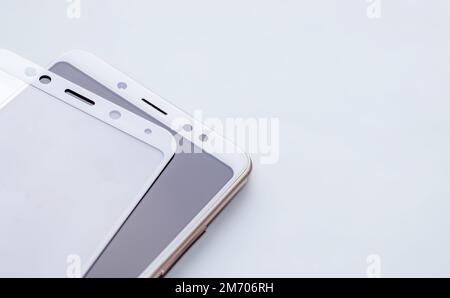 maintenance and repairing smartphones. many tempered glass screen protector and mobile phone, replace concept Stock Photo