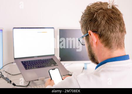 Computer programmer writing program code on computer in office Stock Photo