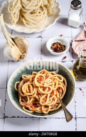 Pici all'aglione Tuscan pasta with garlic sauce Stock Photo