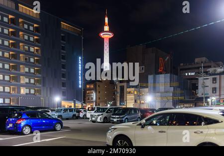 Kyoto, Japan - January 1, 2023: Kyoto Tower over full hotel parking lot in city center Stock Photo