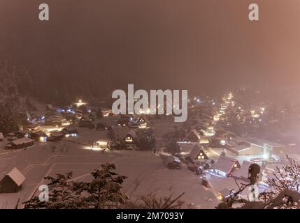 Shirakawa-go Houses Bathed in Pink Snowy Mist on Winter Night Stock Photo