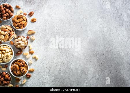 Assortment of nuts in bowls. Cashew, hazelnuts, pecan, almonds, brazilian nuts and pistachios. Stock Photo