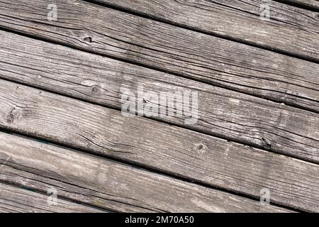 Old faded boards on a deck or outdoor table in the midday sun in close-up. Stock Photo