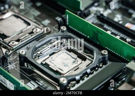 Man engineer,collector.Independent self computer assembly. Mounting in sockets processor,random access memory RAM,motherboard,fan. Assembly of home cr Stock Photo