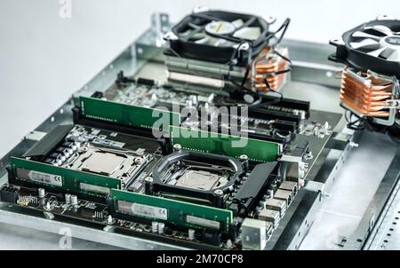 Man engineer,collector.Independent self computer assembly. Mounting in sockets processor,random access memory RAM,motherboard,fan. Assembly of home cr Stock Photo