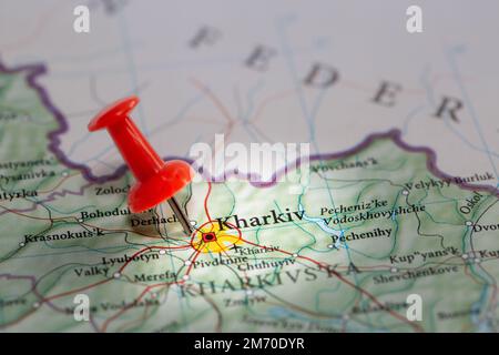 A red push pin marking the location of the Ukrainian city of Kharkiv close to the Russian border during the Special Military Operation or war Stock Photo