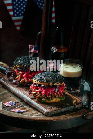 pulled pork burger with black sesame with Crunchy Apple Slaw, Pickled Red Cabbage, Crunchy Apple Slaw, American Flag, USA Independence Day Stock Photo