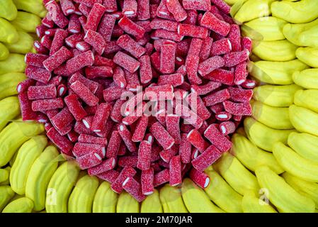 many colored marmalade candies laid out on a flat surface; dessert for the holiday; sweet gifts for children; texture and background with small candie Stock Photo