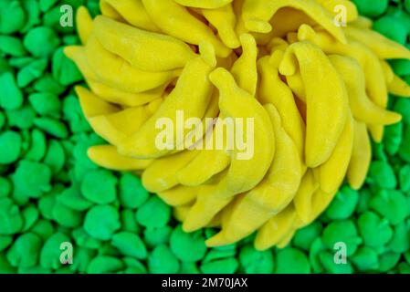 many colored marmalade candies laid out on a flat surface; dessert for the holiday; sweet gifts for children; texture and background with small candie Stock Photo