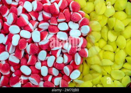 many colored marmalade candies laid out on a flat surface; dessert for the holiday; sweet gifts for children; texture and background with small candie Stock Photo