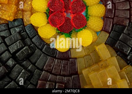 many colored marmalade candies laid out on a flat surface; dessert for the holiday; sweet gifts for children; texture and background with small candie Stock Photo