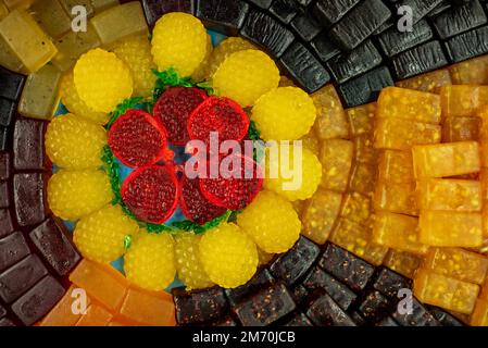 many colored marmalade candies laid out on a flat surface; dessert for the holiday; sweet gifts for children; texture and background with small candie Stock Photo