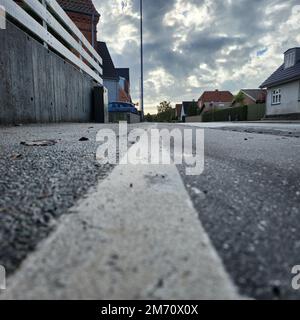 The line on the road that separates bikes from pedestrians in small town Denmark Stock Photo