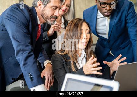Japanese business woman working with colleague, senior adult business and finance worker Stock Photo