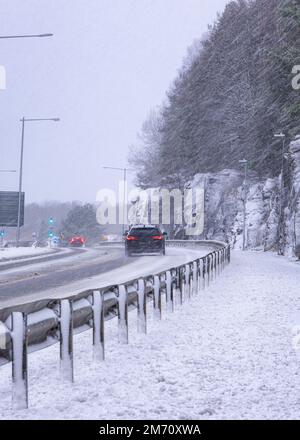 An station vagen car driving through snowy road during snow storm in gothenburg sweden Stock Photo