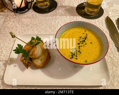 Appetizer, pumpkin cream soup with shrimp on a finely decorated table, Hesse, Germany Stock Photo