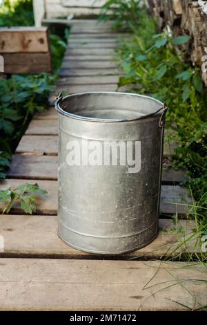 iron bucket with water in the country in the summer Stock Photo