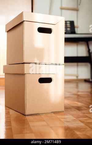 boxes on top of each other close-up on the floor. Moving theme with cardboard boxes Stock Photo