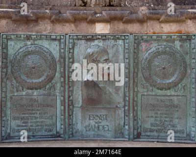 Bronze plaque in honour of the author of the colossal statue Hermann Monument Ernst von Bandel in front of the Hermann Monument, Teutoburg Forest Stock Photo