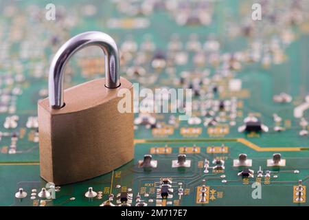 Computer security concept. Padlock on green computer circuit board Stock Photo
