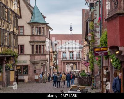 Colourful half-timbered houses and tourists in the Rue du General de Gaulle and in the background town hall Hotel de Ville, Riquewihr, Reichenweier Stock Photo