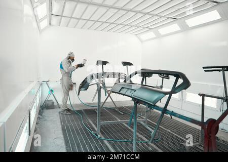 Man doing color restoration for car parts Stock Photo