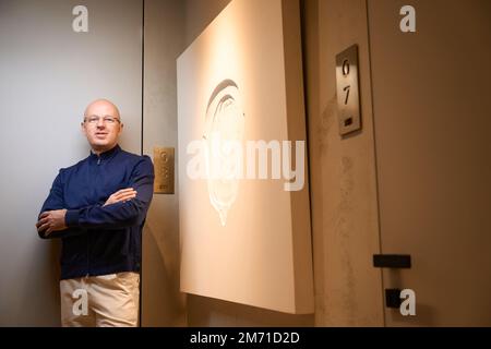 Man stands in the lobby of a modern building Stock Photo