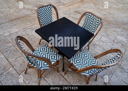 Table and chairs in the open air street cafe in Tel Aviv Stock Photo