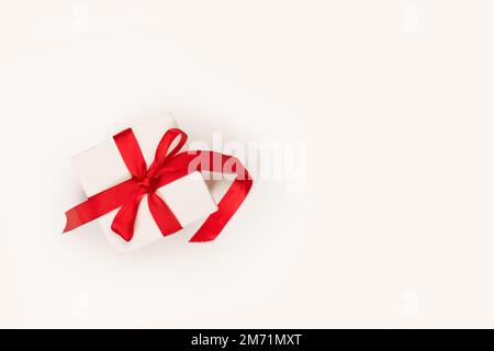 White box with red bow on a white background with copy space Stock Photo
