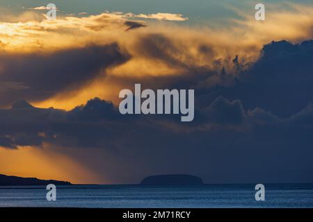The setting sun lighting up the cloud cover Stock Photo