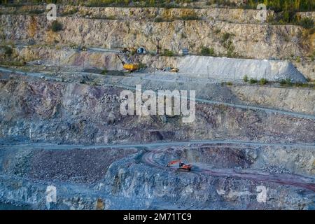 Dolomite quarry Photo from the top. Industrial terraces in a mining quarry. Aerial view of open pit mining. Excavation of the Dolomite Mine. Extractiv Stock Photo