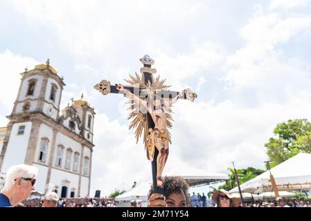 Salvador, Bahia, Brazil - January 06, 2023: Catholics touching the image of Jesus Christ during mass at Senhor do Bonfim church, in the background, in Stock Photo