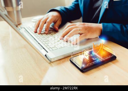 businessman using laptop and smartphone screen display and technology advances in communications for business. The hologram concept of advancement in Stock Photo