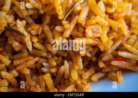 nigerian Jollof Rice served with plantain and stew Stock Photo