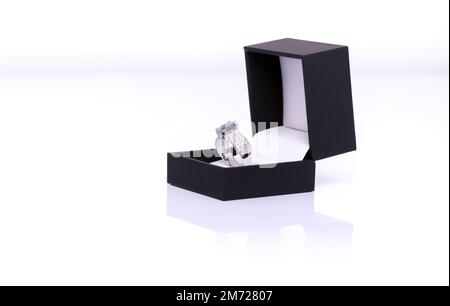 Platinum ring with blue sapphire and diamond in dark blue jewel box. Collection of natural gemstones accessories. Studio shot Stock Photo
