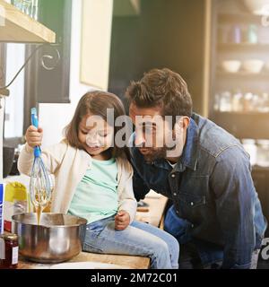 Nothing better than food, family and fun. a father and daughter making pancakes together. Stock Photo