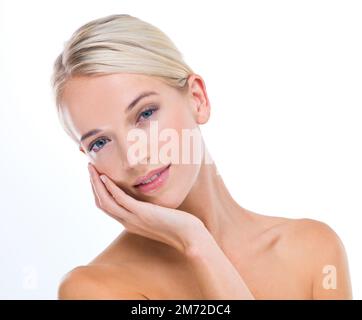 Soft to the touch. A studio portrait of a beautiful young woman touching her soft skin. Stock Photo