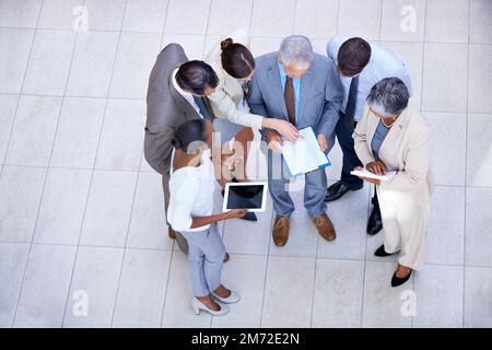 Analyzing the quarterly results. a group of diverse businesspeople discussing paperwork. Stock Photo